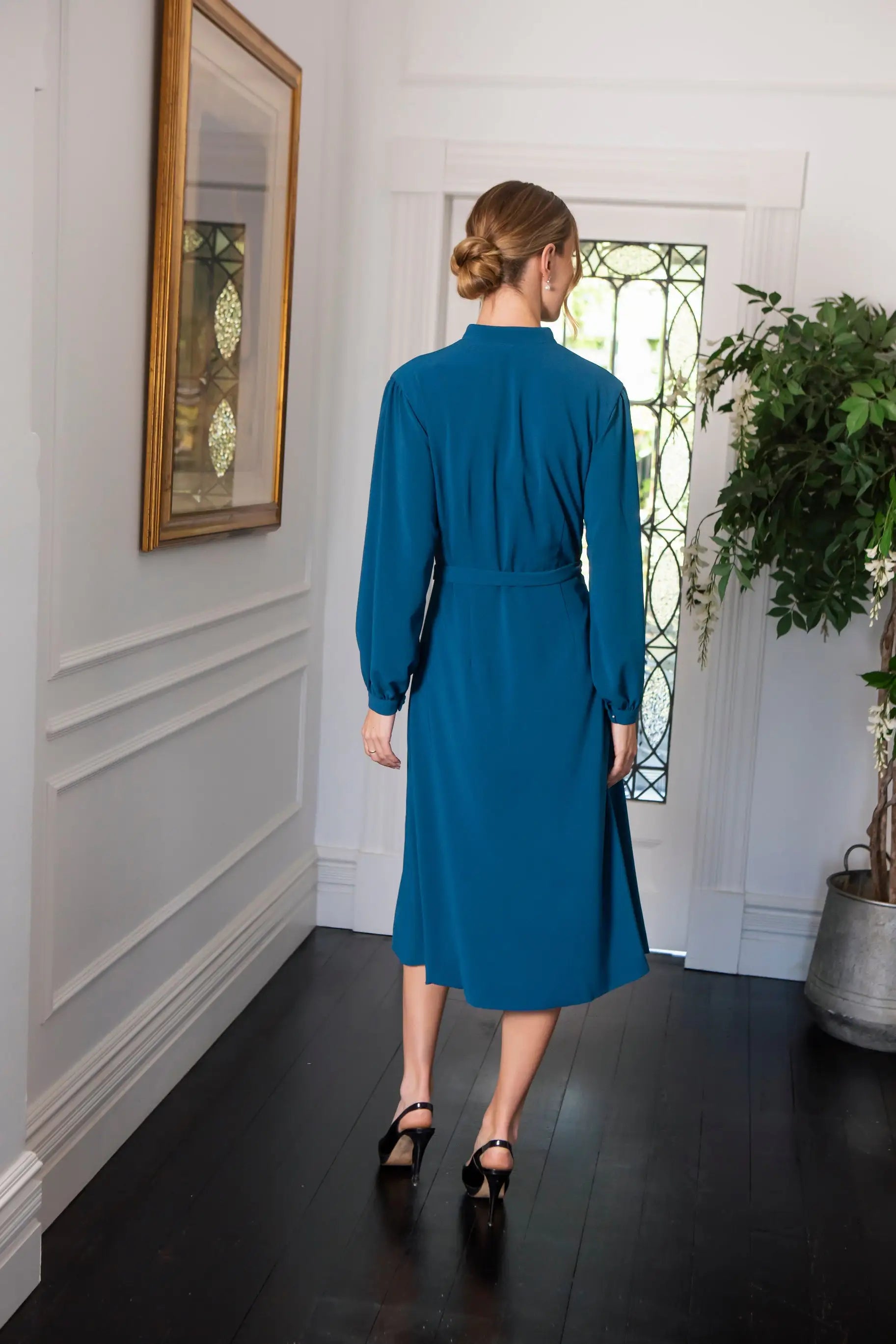 Woman in blue button fastening dress