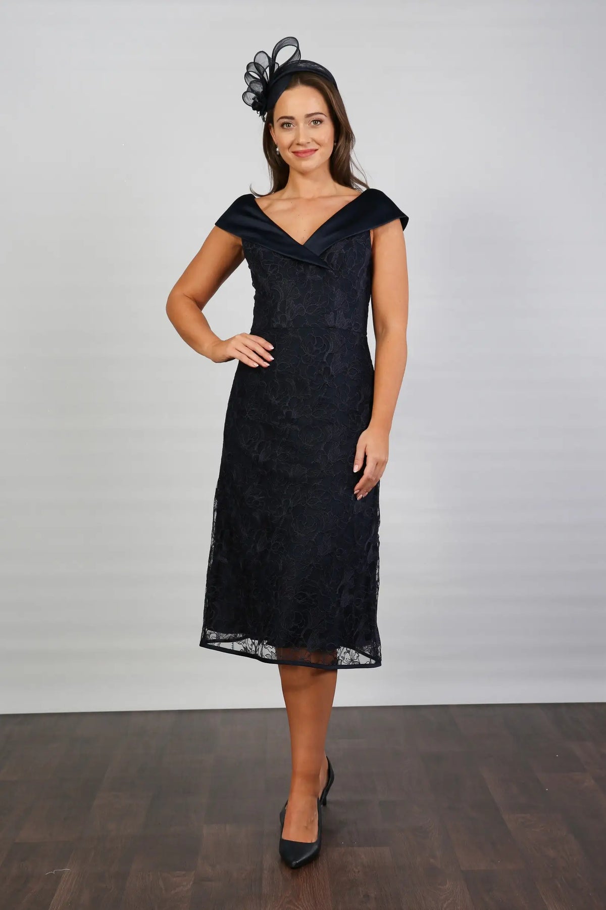 A woman in a Satin and Lace Navy occasion dress.