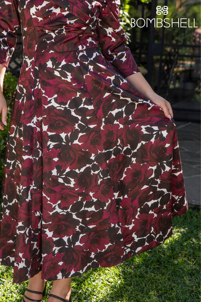 Person wearing a burgundy floral dress with &