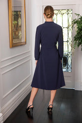 Woman in navy button fastening dress