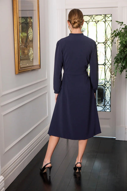Woman in navy button fastening dress