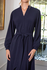 Woman in navy button fastening dress