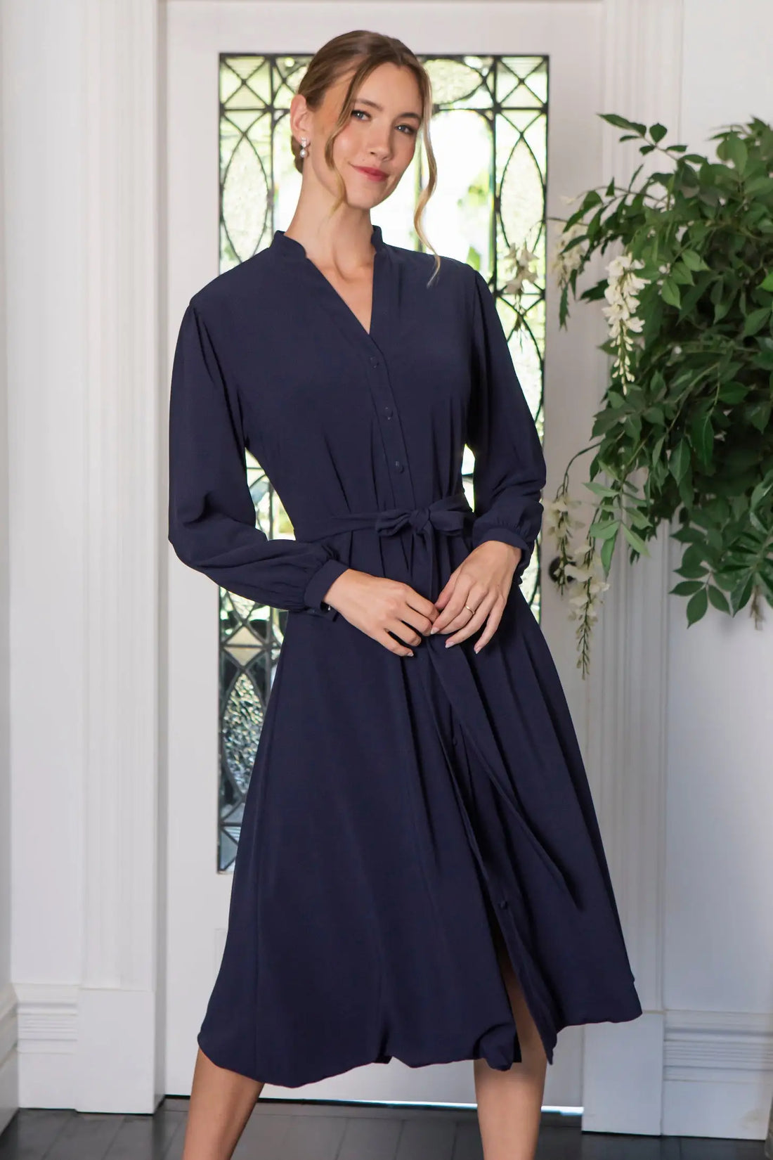 Woman in navy button fastening dress