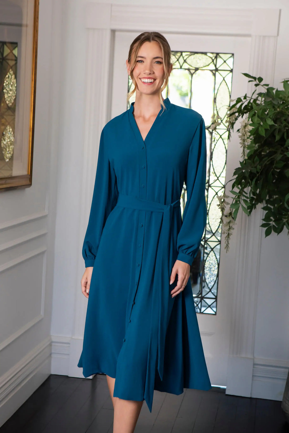 Woman in blue button fastening dress