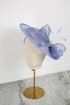 Blue decorative hat on a mannequin head with a white background