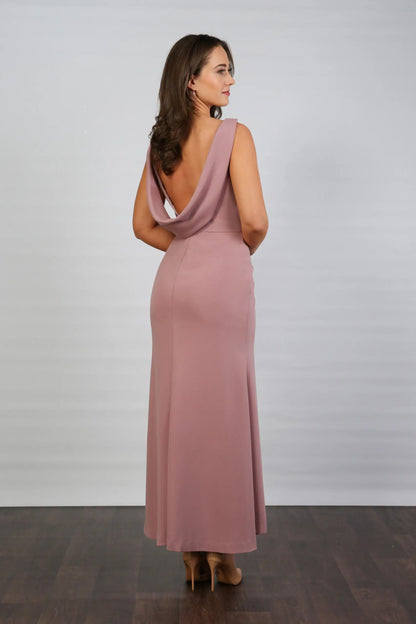 A model wearing a sleeveless, V-neck, dusty rose maxi dress with a deep cowl back and pleated waist, suitable for day to evening events.