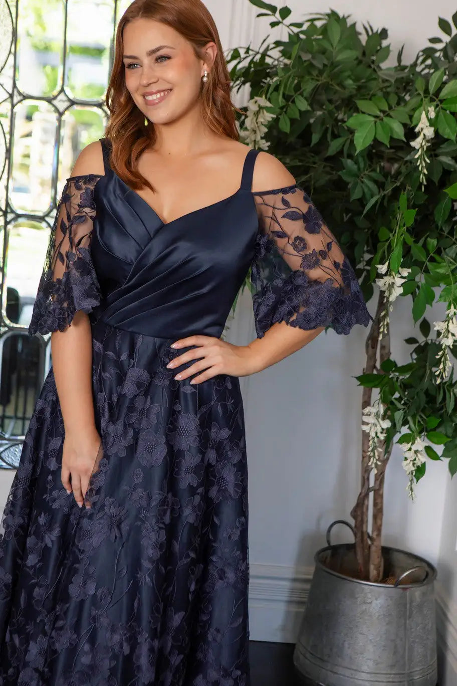 Woman in navy lace occasion dress