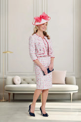 Woman in a stylish outfit with a pink hat in an elegant room.