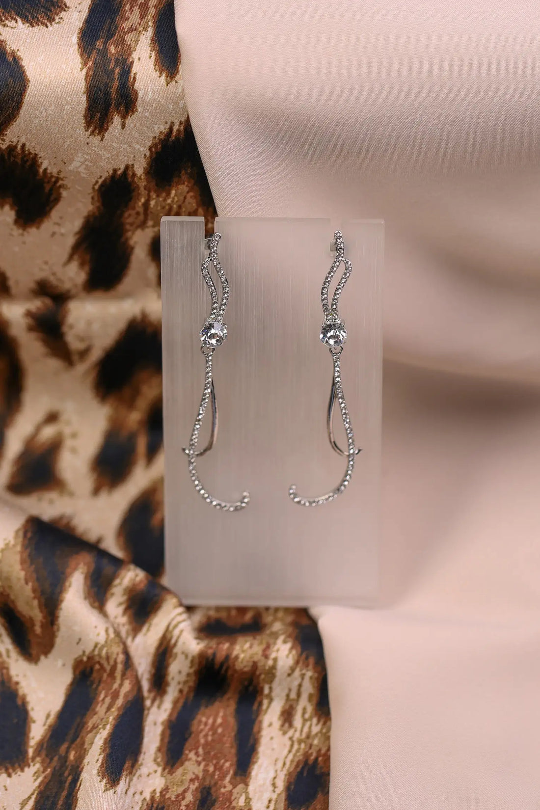 Silver long curved earrings with sparkle crystals.