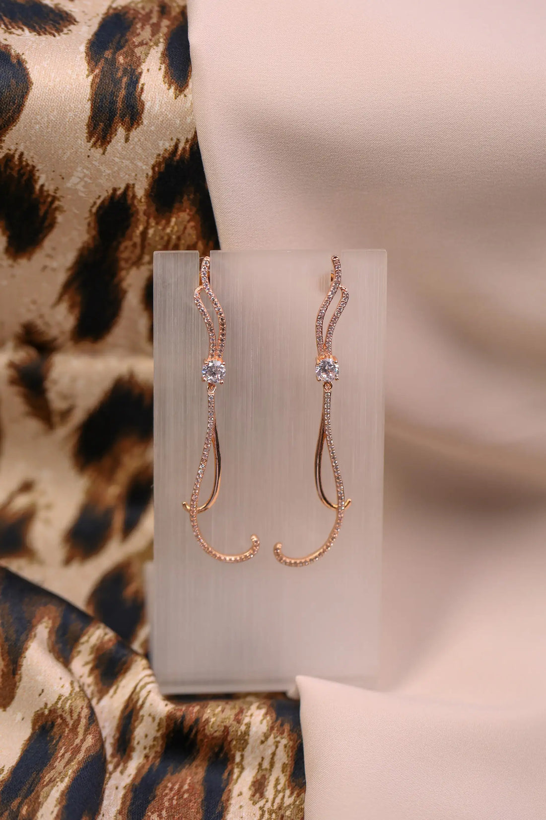 Rose gold long curved earrings with sparkle crystals.