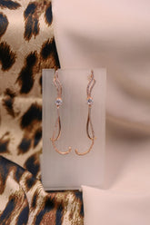 Rose gold long curved earrings with sparkle crystals.