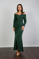 A woman models an off-the-shoulder, long-sleeved, green stretch jersey evening dress.