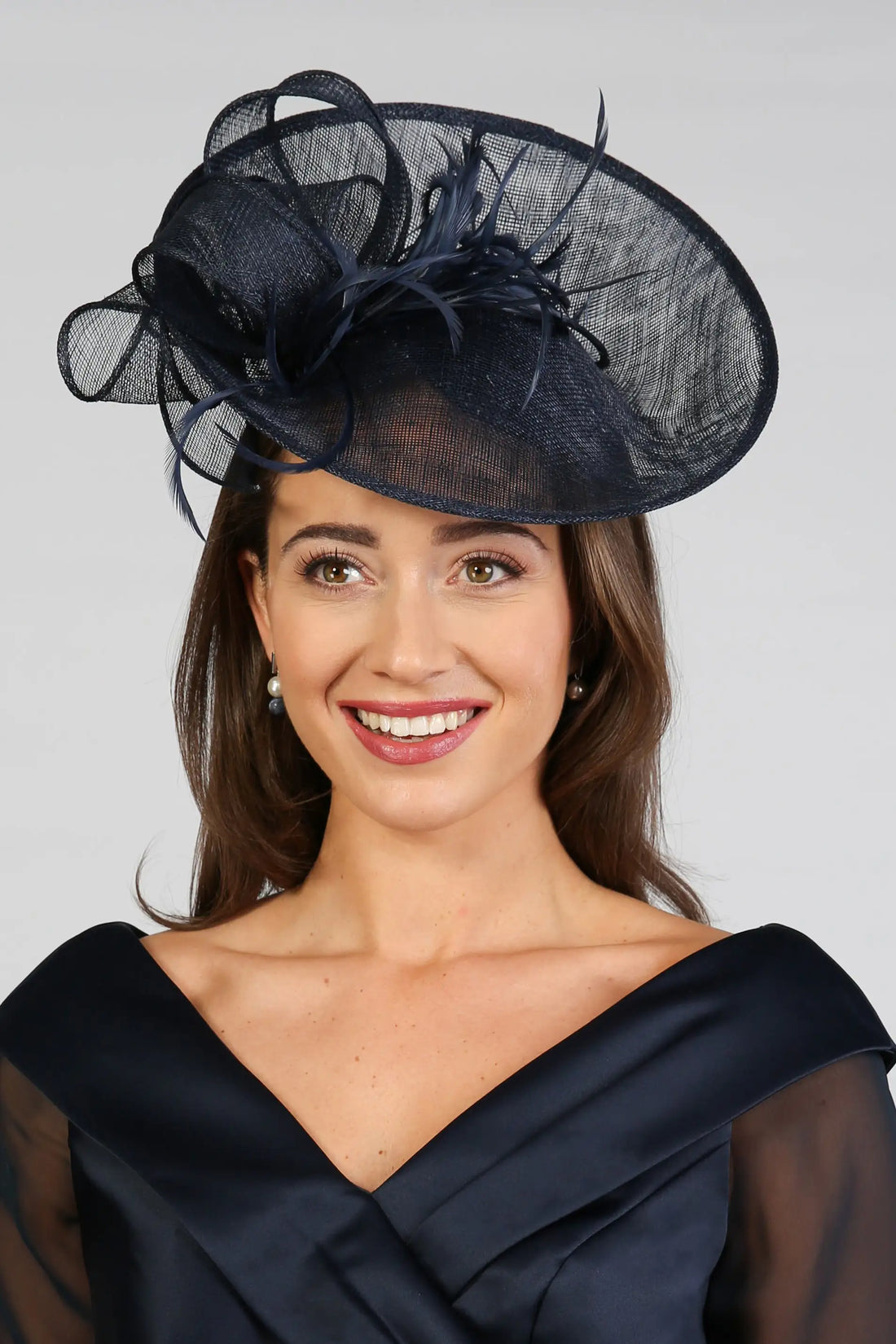 Woman wearing a dark navy fascinator
