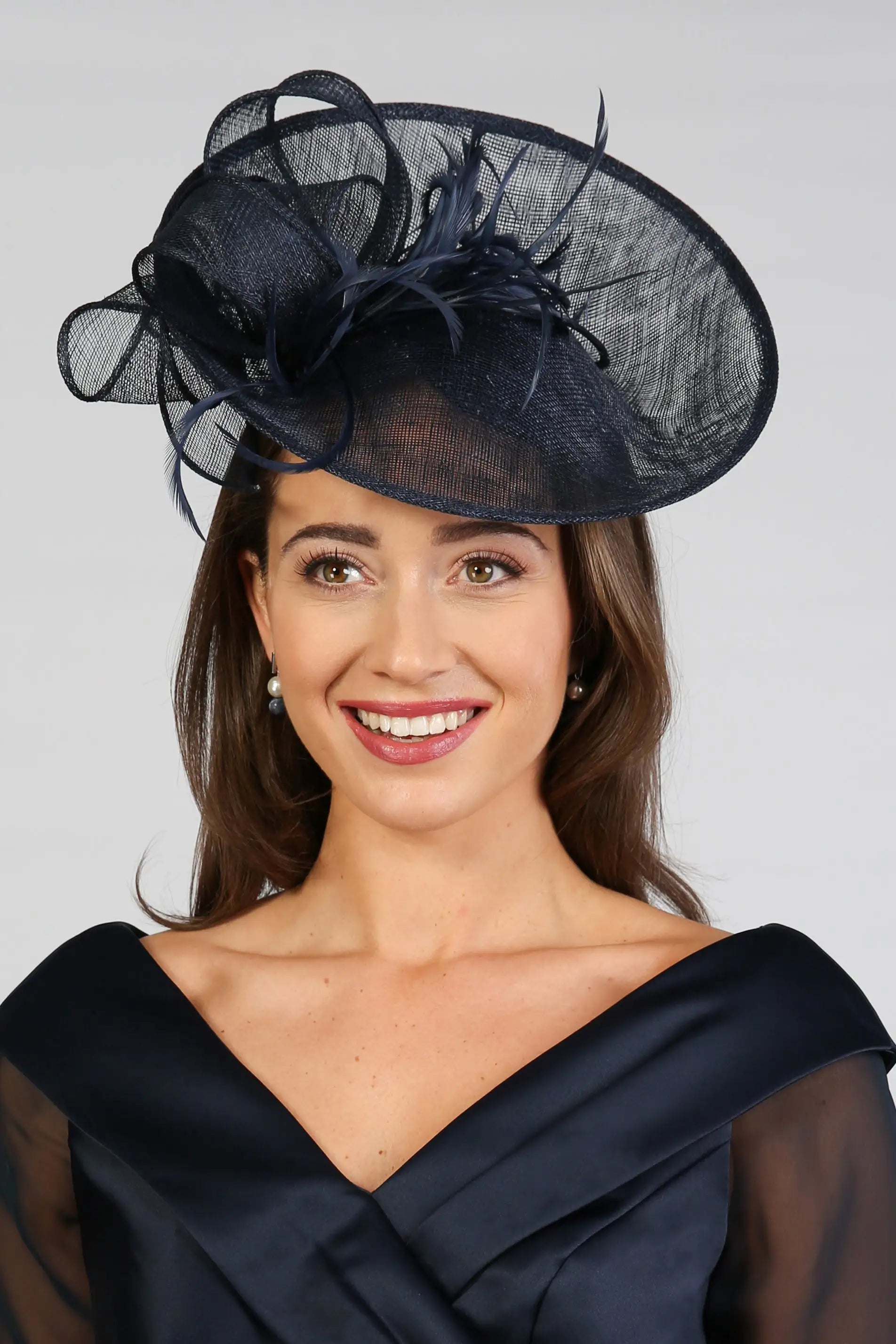 Woman wearing a dark navy fascinator