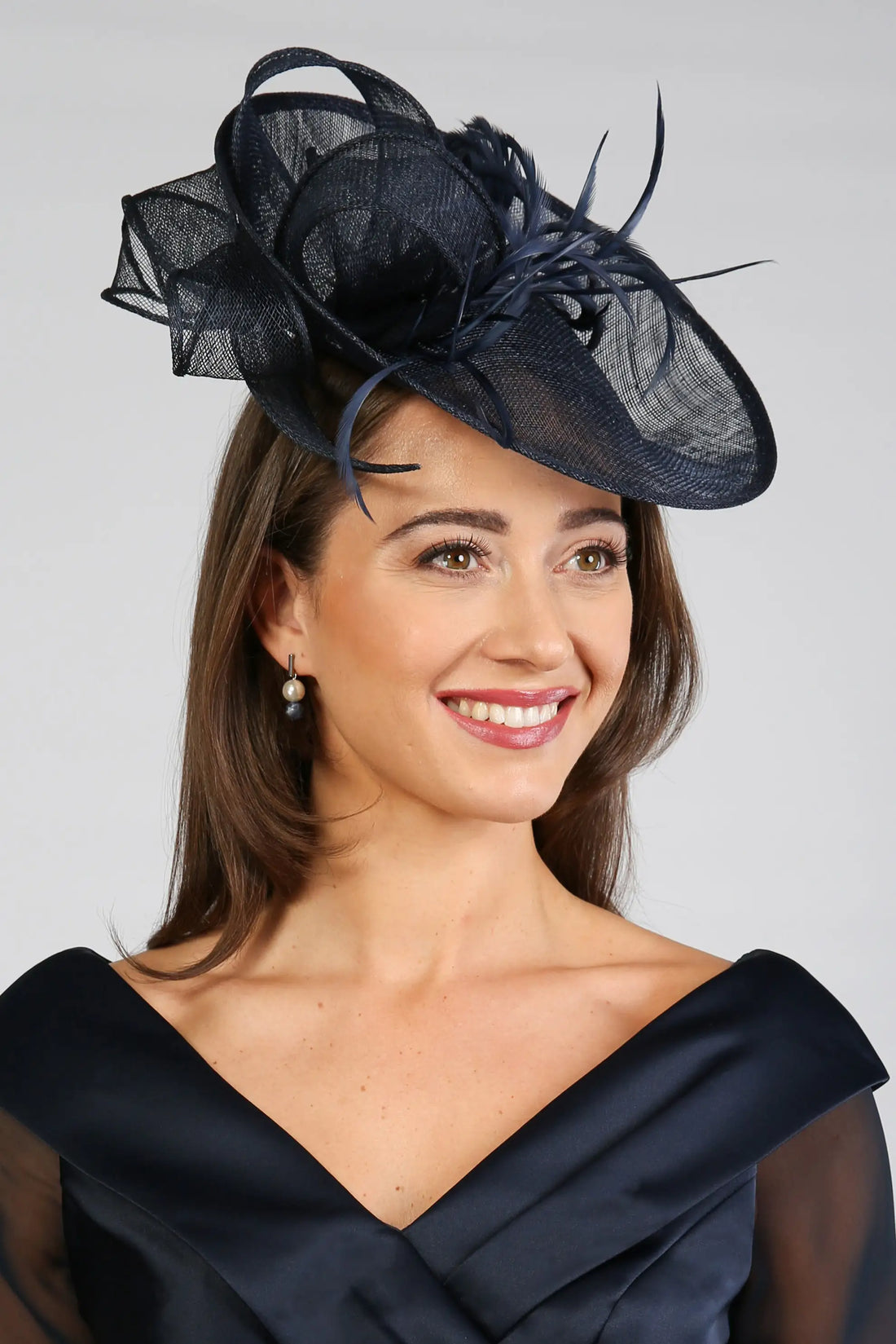 Woman wearing a dark navy fascinator