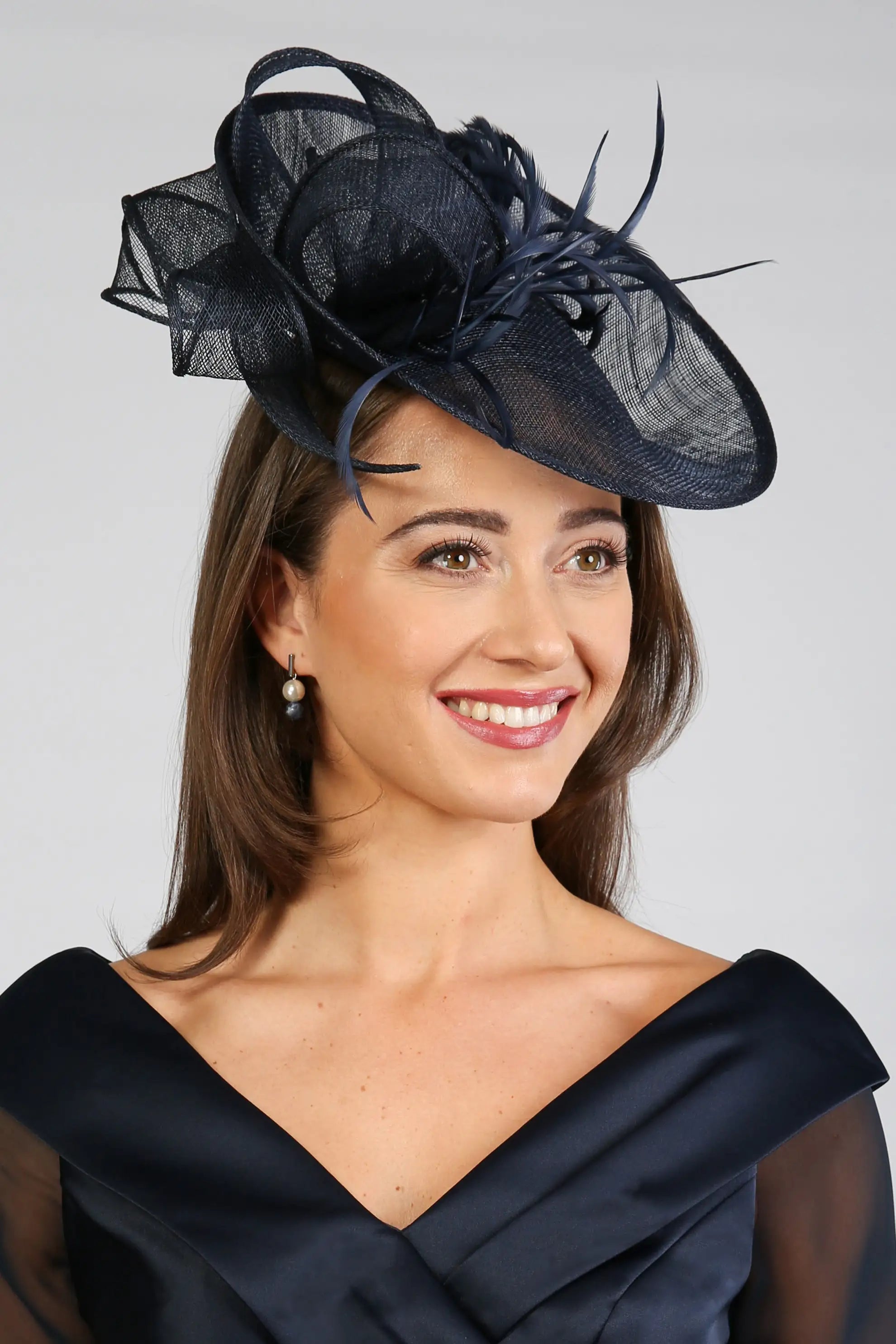 Woman wearing a dark navy fascinator