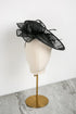 Black decorative hat on a mannequin head with a white background