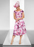 Woman wearing a pink floral dress and matching hat on a white platform.