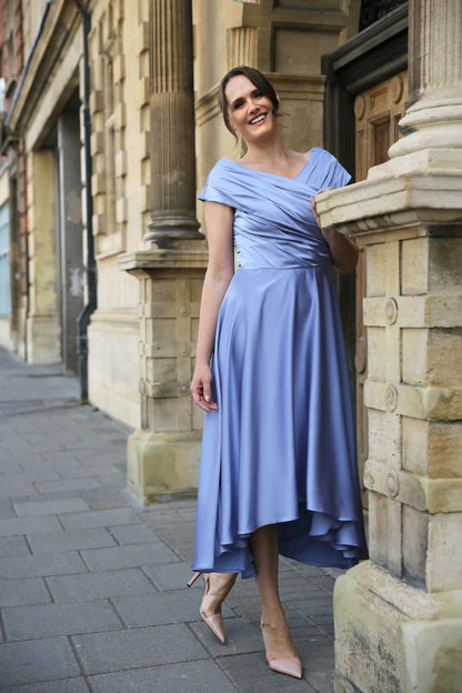 Woman wearing a blue satin occasion dress.