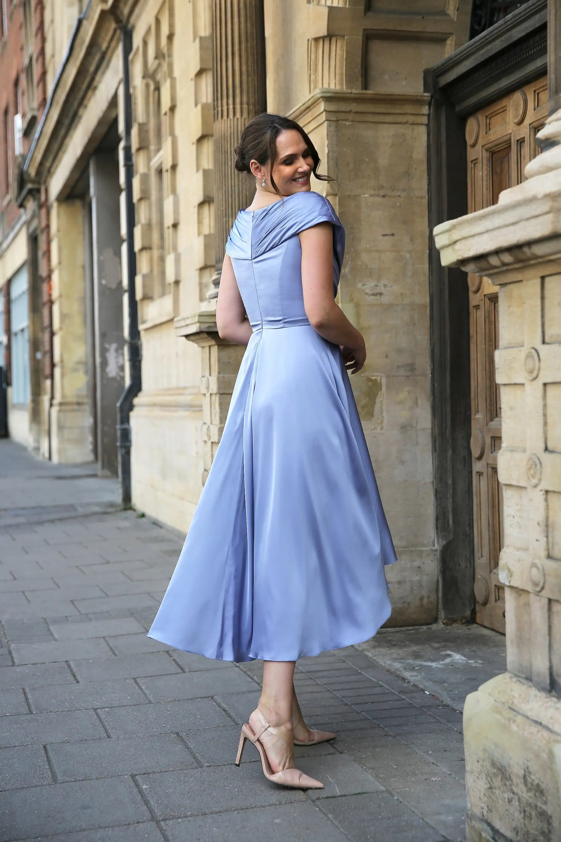 Woman wearing a blue satin occasion dress.