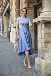 Woman wearing a blue satin occasion dress.