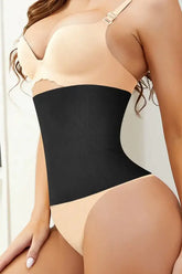A close-up image of a person wearing a black waist smoother shapewear, focusing on the waist area showing the smoothing effect.