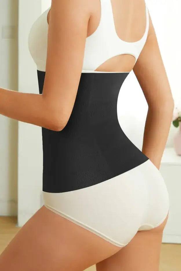 A close-up image of a person wearing a black waist smoother shapewear, focusing on the waist area showing the smoothing effect.