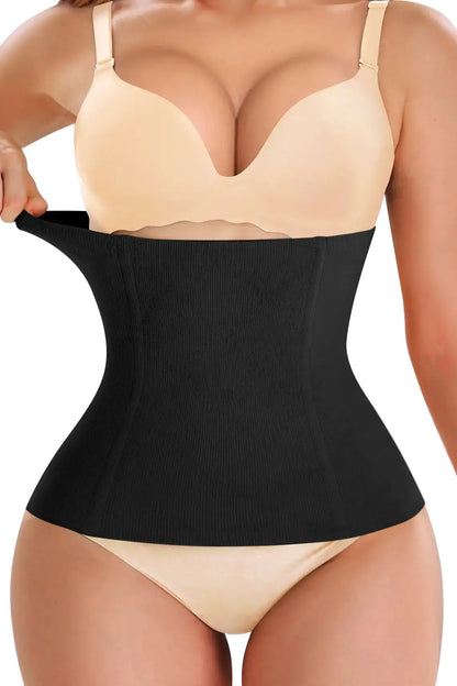 A close-up image of a person wearing a black waist smoother shapewear, focusing on the waist area showing the smoothing effect.