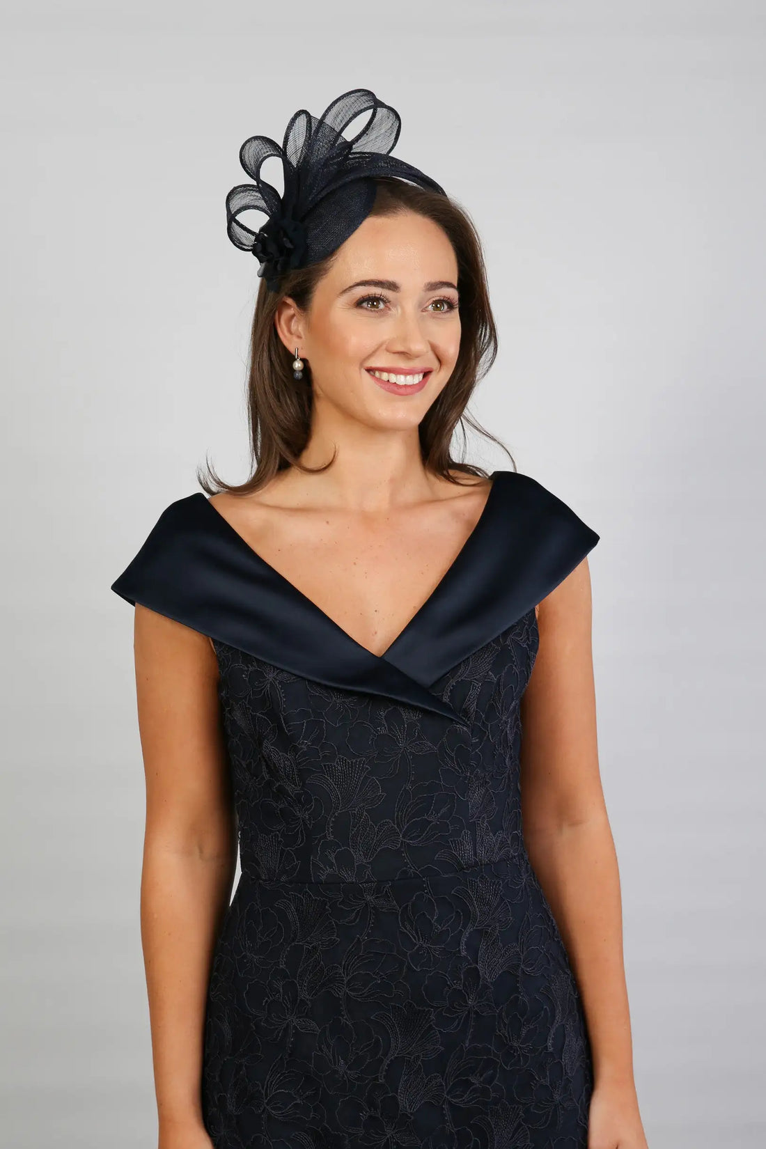 A woman in a Satin and Lace Navy occasion dress.