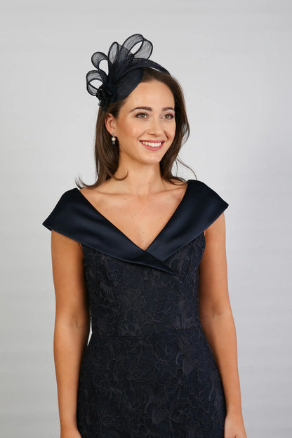 A woman in a Satin and Lace Navy occasion dress.