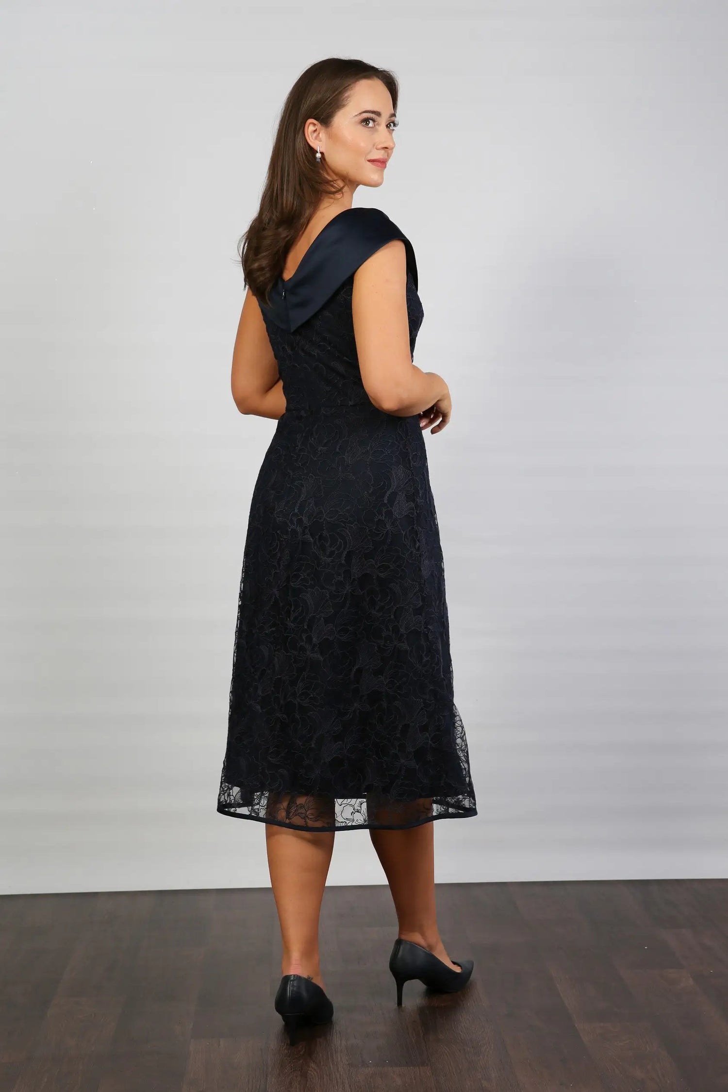 A woman in a Satin and Lace Navy occasion dress.