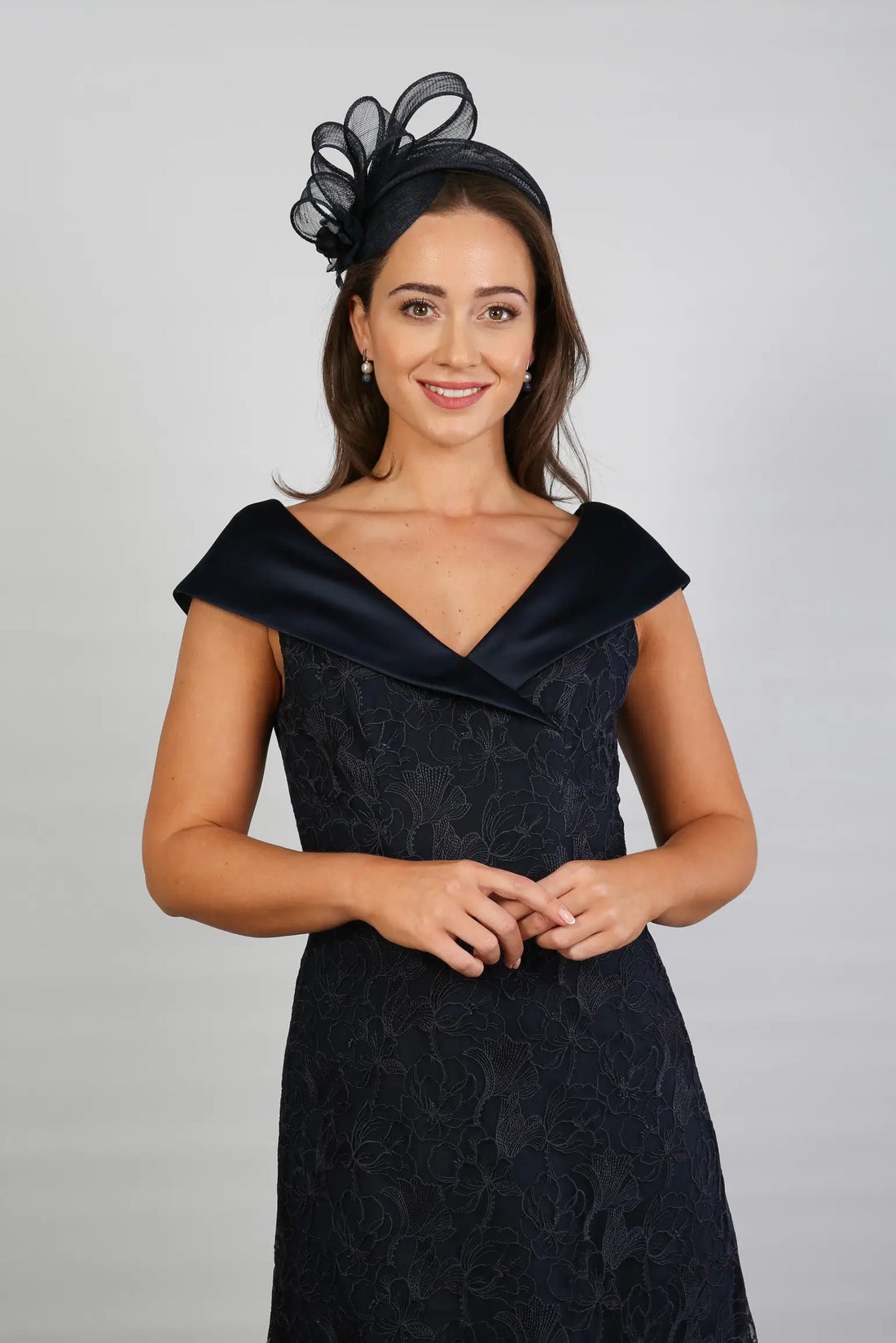 A woman in a Satin and Lace Navy occasion dress.