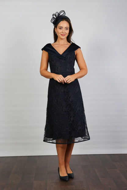 A woman in a Satin and Lace Navy occasion dress.