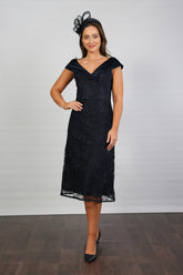 A woman in a Satin and Lace Navy occasion dress.