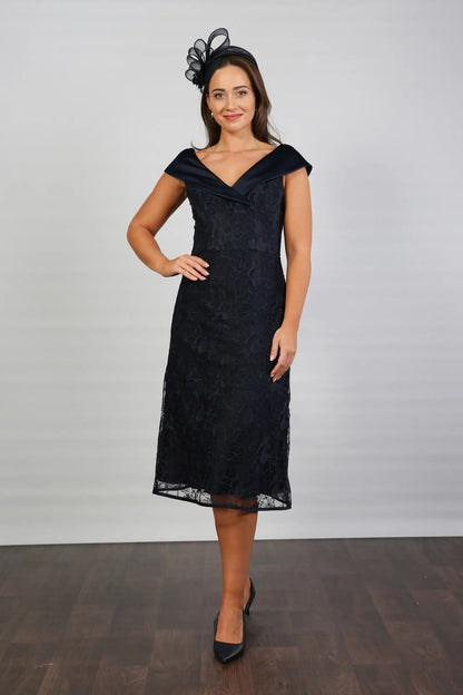 A woman in a Satin and Lace Navy occasion dress.