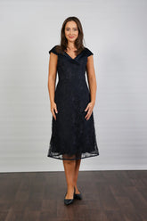 A woman in a Satin and Lace Navy occasion dress.
