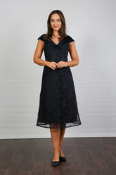 A woman in a Satin and Lace Navy occasion dress.