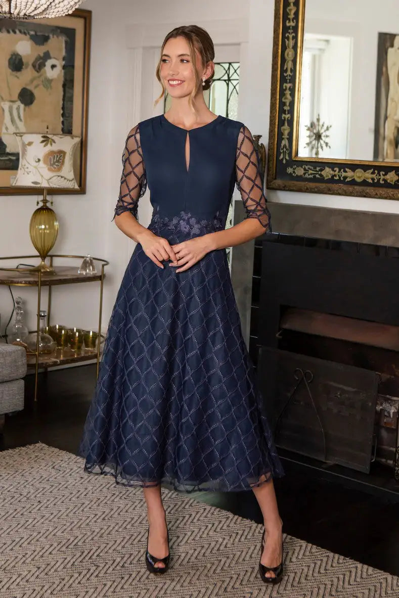 Woman in navy midi occasion dress