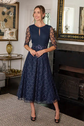Woman in navy midi occasion dress