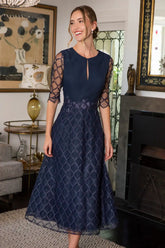 Woman in navy midi occasion dress