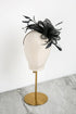 Black decorative headpiece on a mannequin head with a white background